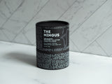 OLPHACTORY CANDLES. The Mingus from The Quartet Discovery Collection. Four 4oz. Matte Black Tins in the Tribal print design tube. Front view.